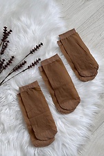 A set of three pairs of thin 20 denier nylon socks in beige  8055093 photo №2