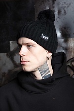 Warm black knitted hat with pompom and lapel Custom Wear 8025384 photo №1