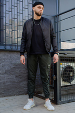 Зеленые коттоновые штаны карго на манжетах с рефлективом и большими карманами Without 8048490 фото №3