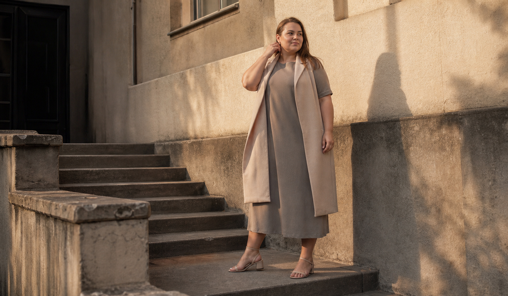 A taupe LULU dress with a beige NADIN vest in a plus-size look for a cool day